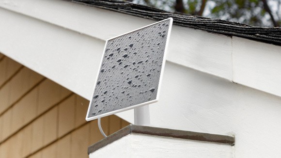 Roku Solar Panel with raindrops on it attached to a roof
