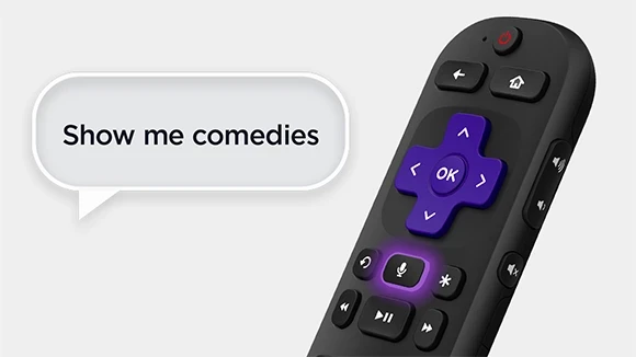 Image of person using the voice search function on the remote.