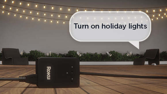 Roku Outdoor Smart Plug SE plugged into outdoor patio lights being turned on using voice control