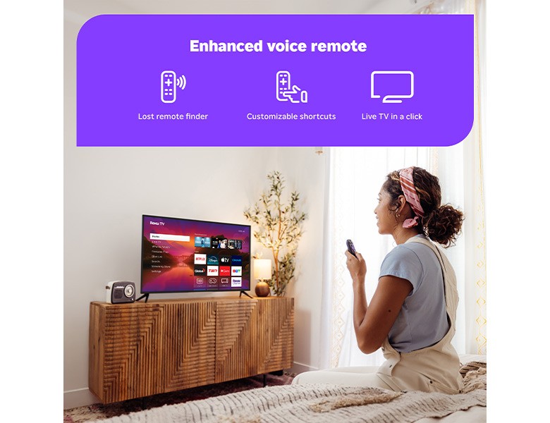 Person using the Roku Enhanced Voice Remote to control their Roku Plus Series Mini-LED TV