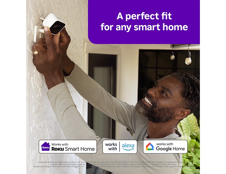 A Roku Outdoor Wired Camera being mounted to an outside wall of a smart home