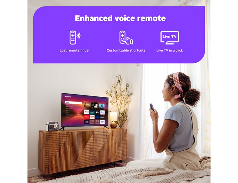Person using the Roku Enhanced Voice Remote to control their Roku Plus Series Mini-LED TV
