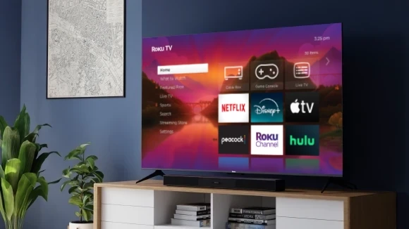 Roku Select Series 4K TV and Roku TV Wireless Soundbar on a credenza