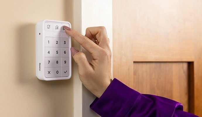 Person activating their Roku Smart Home Keypad