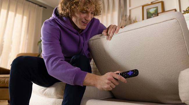 Roku Remote next to the remote finder button on a Roku Plus Series TV