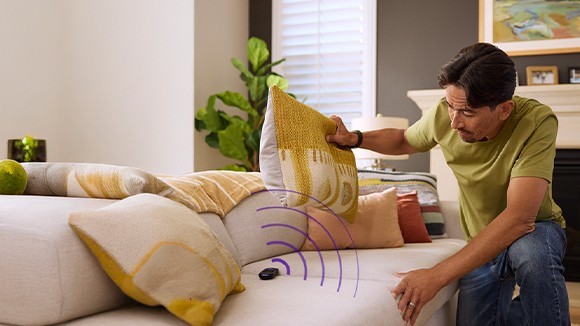 Person searching for a remote under a couch cushion