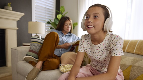 Person wearing headphones while watching their Roku TV